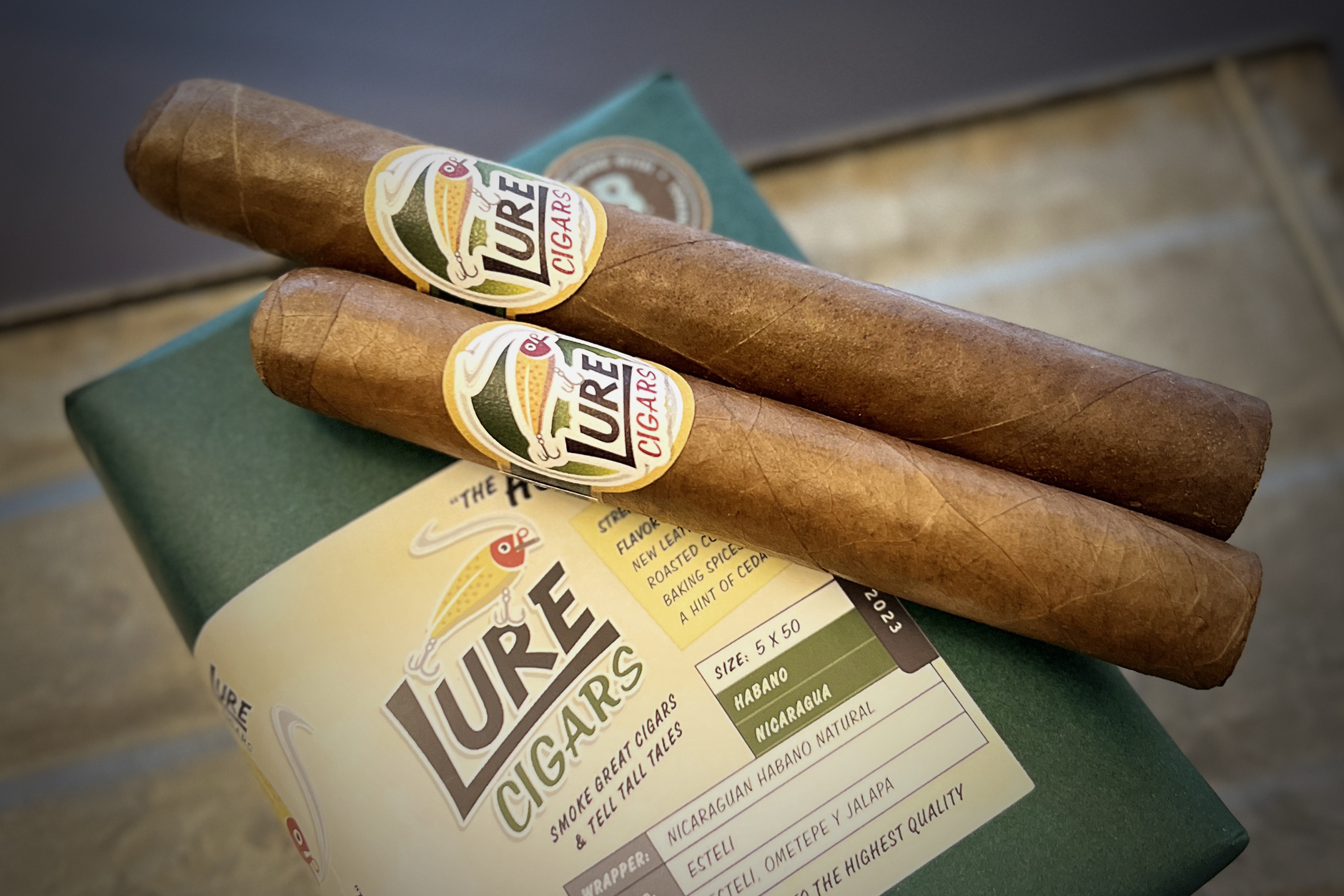Two Lure cigars propped up on package